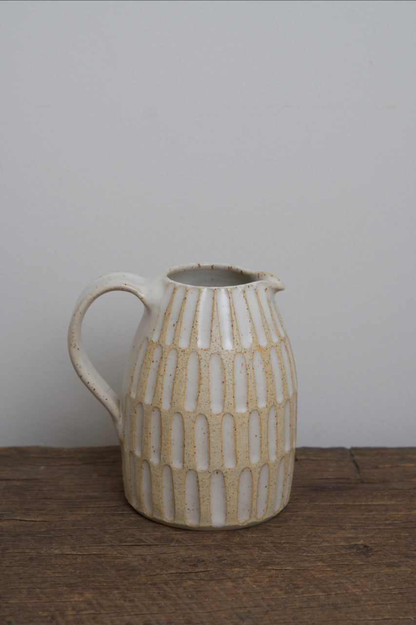 Carved pouring jugs