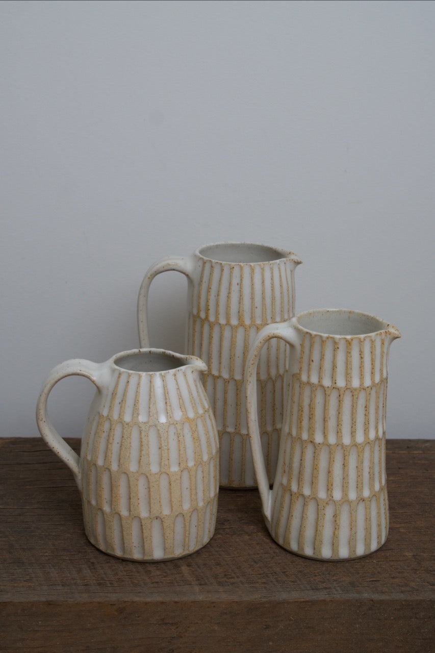 Carved pouring jugs