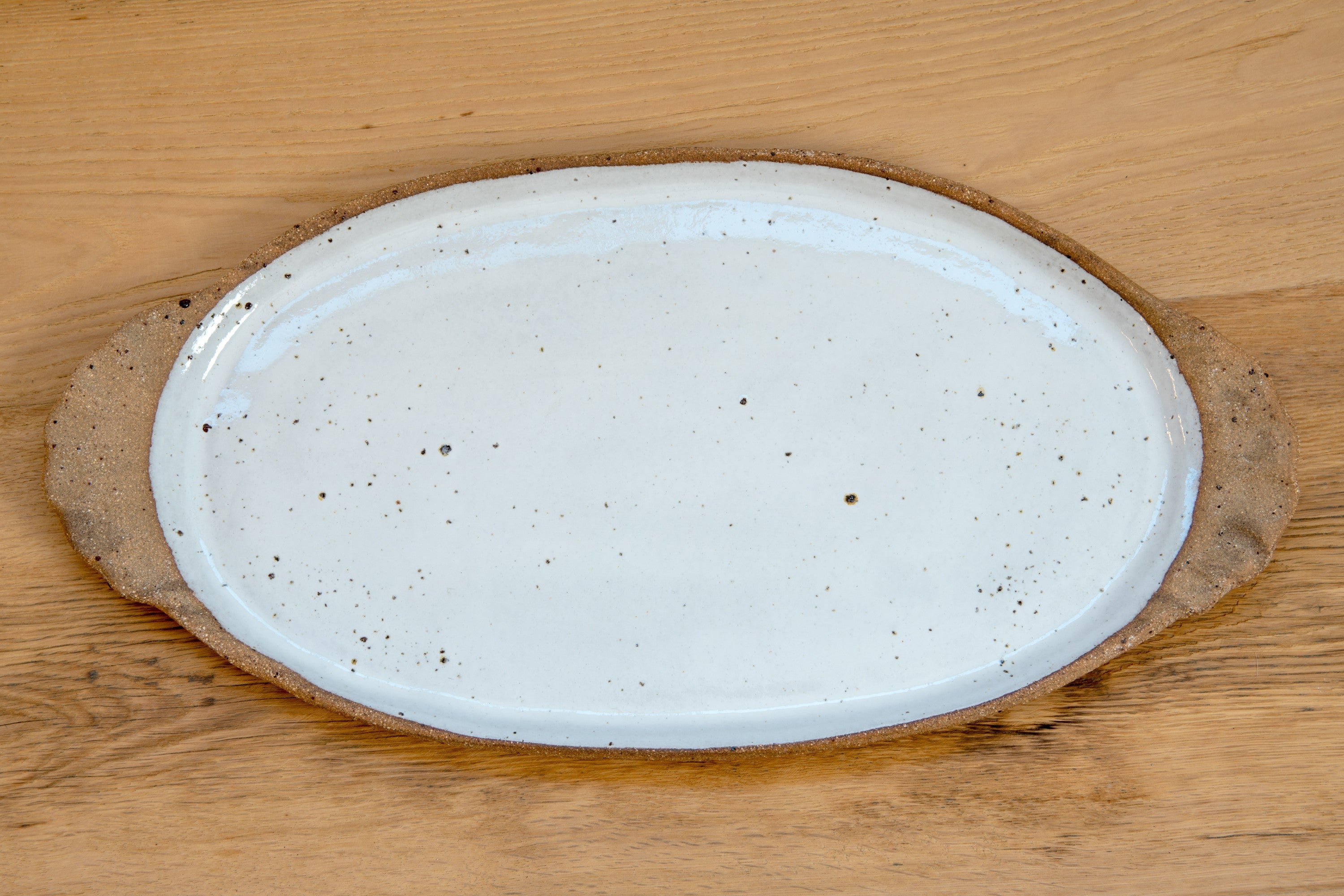 Oval platter with curly handles